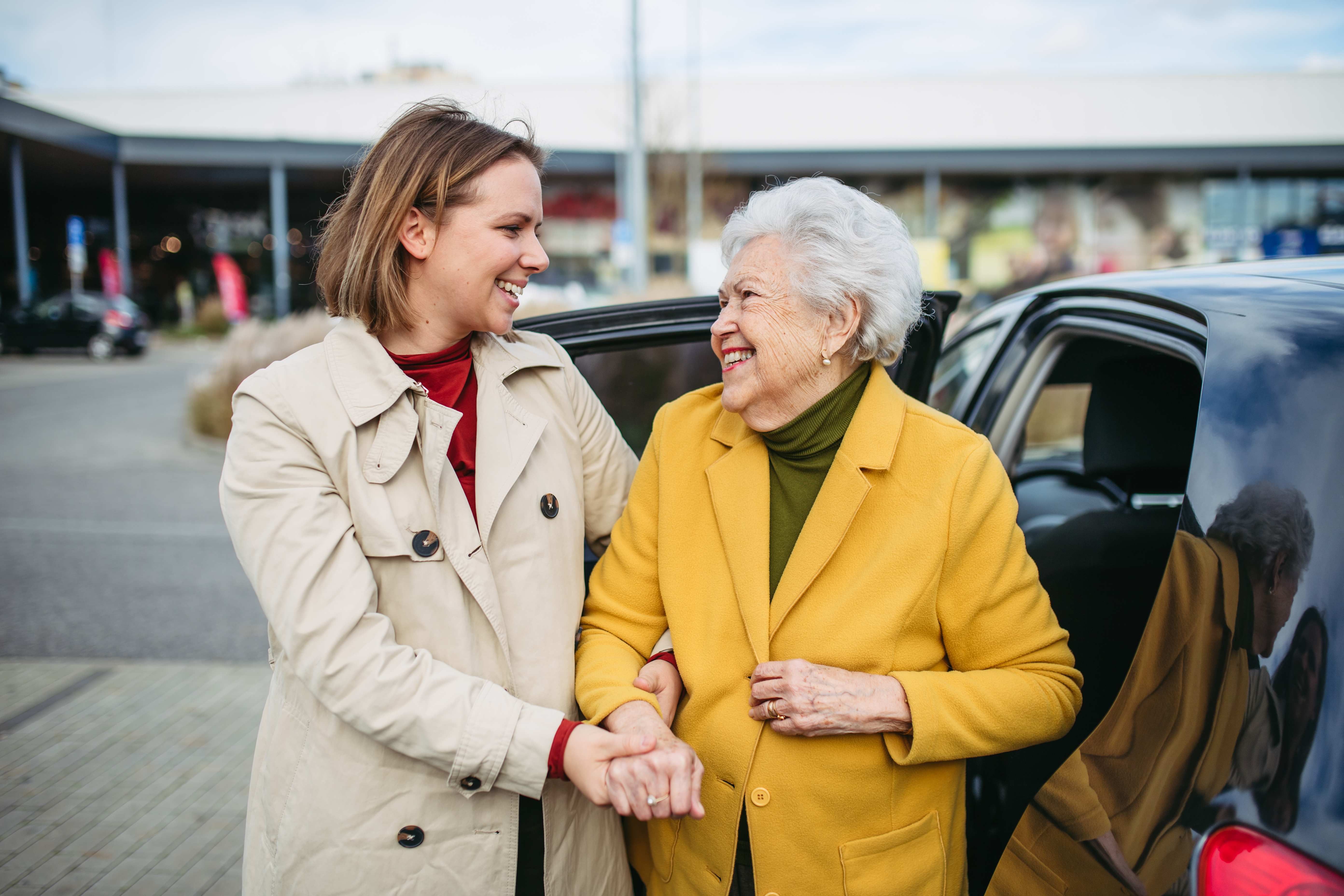 Caring health aide helping a senior woman